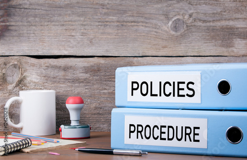 Fotomural Policies and Procedure. Two binders on desk in the office. Busin