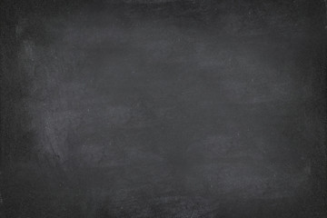 Black Chalkboard blackboard chalk texture background. Black chalk board texture empty blank with writing chalk traces erased on the board. Copyspace for text advertisement. School board display.