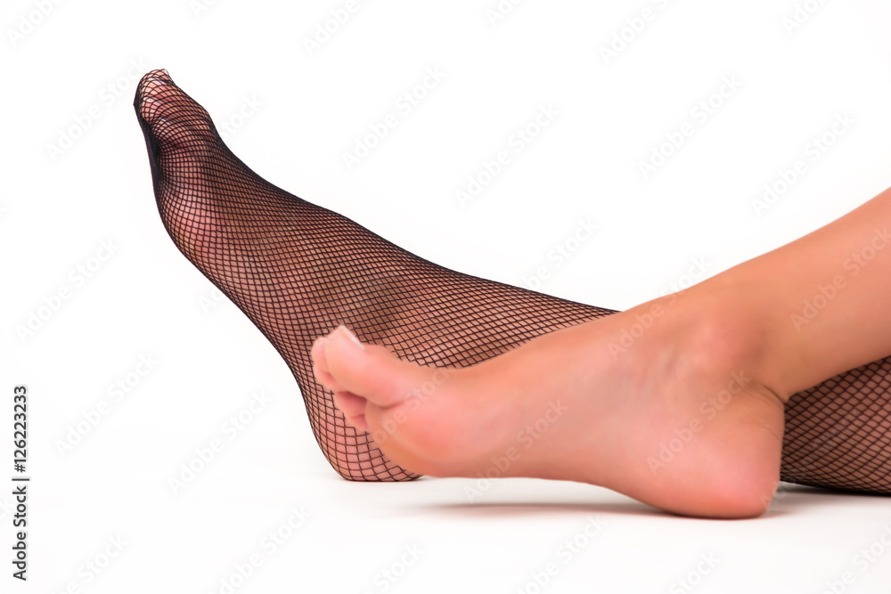 Woman's feet on white background. Foot in fishnet stocking. Elegance and  sensuality. Skin and cloth. Stock Photo | Adobe Stock