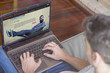 © GENETTICA - Pay per view concept: Young man at home viewing series streaming web on laptop.