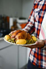 Wall Mural - young man preparing a roast turkey