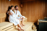 Beautiful couple relaxing in sauna