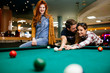 © NDABCREATIVITY - Happy friends enjoying playing pool
