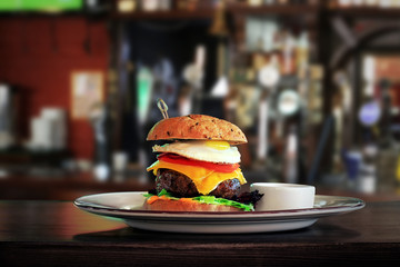 Delicious big hamburger on plate in restaurant