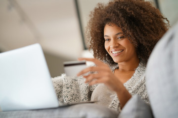 Wall Mural - Beautiful mixed-race woman shopping on internet