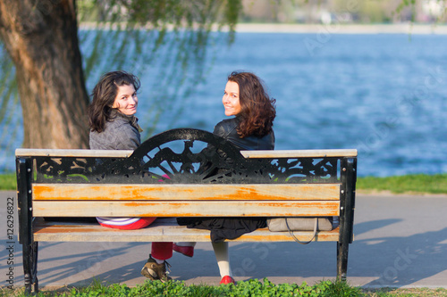 Best friends sitting on a bench Stock-Foto | Adobe Stock