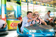 © Halfpoint - Senior couple in the bumper car at the fun fair