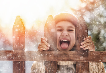 Wall Mural - girl playing on a winter walk