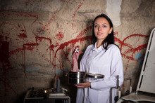 Female Crazy Scientist Holding A Severed Hand And Eyeball In A B