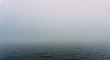 Fog over the water of the lake in autumn day. Abstract background image