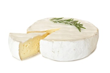Brie cheese with rosemary and cut slice isolated on a white background