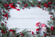 © tachinskamarina - Christmas wooden background with branches of trees, cones, red berries, santa, gnome