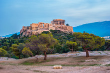 Parthenon And Herodium Construction In Acropolis Hill In Athens, Greece. Beautiful Landscape With Green Trees Around Ancient Architecture.