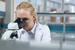 © Myvisuals - Doctor woman with microscope in laboratory. Scientific research.