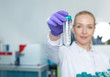 © Myvisuals - portrait of young woman scientist in lab analyzing liquid in ret