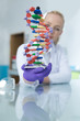 © Myvisuals - Woman scientist holding DNA molecule
