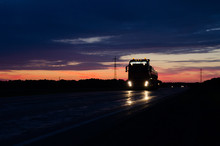 Big Truck Wagon Rides On The Road At Sunset And Sky With Clouds