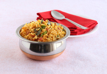 Wall Mural - Indian food tamarind rice, which is a vegetarian, traditional, popular and south Indian rice dish, in a bowl.