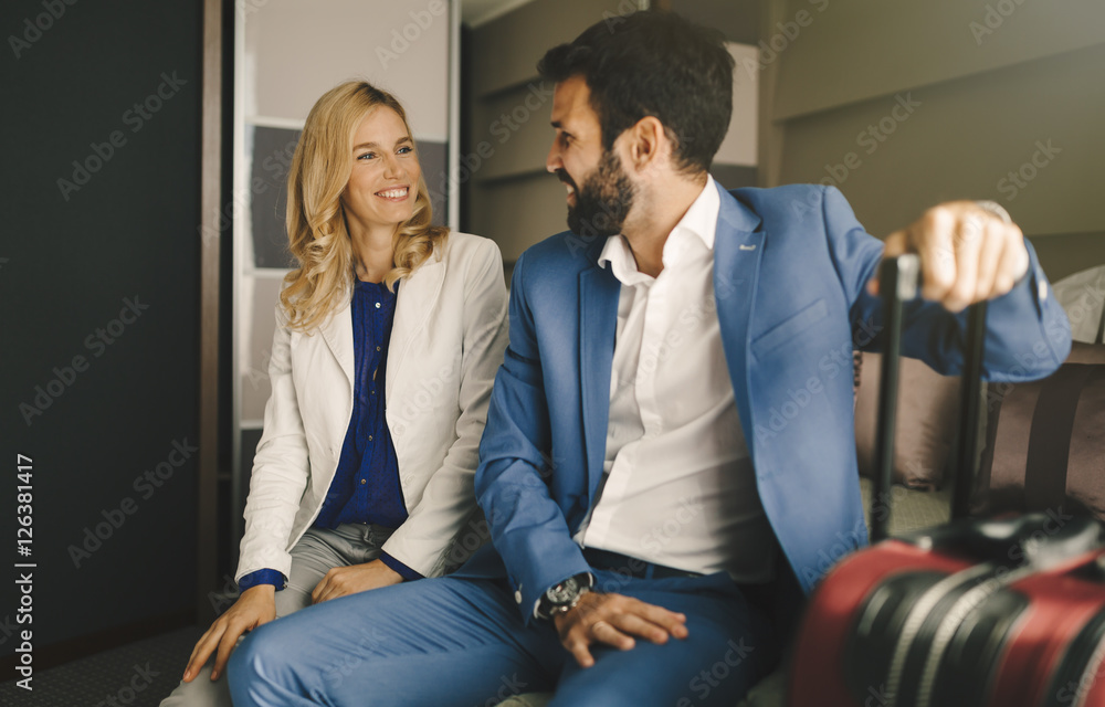Business couple in formal wear traveling