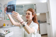 © BalanceFormCreative - A red-haired female dentist carefully examines an X-ray image of a patient's teeth, ensuring precise diagnoses and comprehensive dental care.