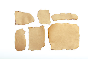 brown ripped pieces of paper on white background