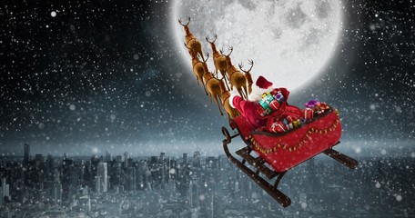 Composite image of high angle view of santa claus riding on sled