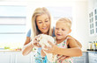 © Flamingo Images - Cute little girl kneading dough with her mother
