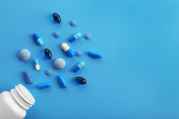 Heap of pills on blue background