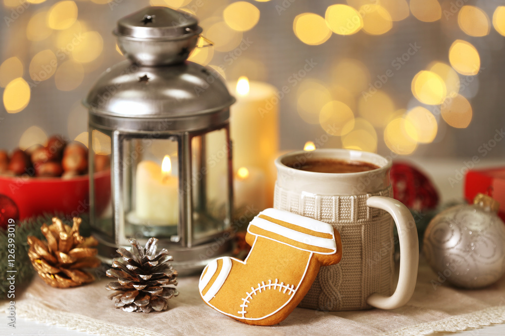 Composition of tasty gingerbread cookie, mug and Christmas decor