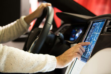HELSINKI, FINLAND - NOVEMBER 04, 2016: The interior of a Tesla Model X electric car with large touch screen dashboard.  Man using gps navigation system. 