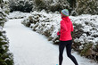 © Iuliia Sokolovska - Winter running in park: happy woman runner jogging in snow, outdoor sport and fitness concept
