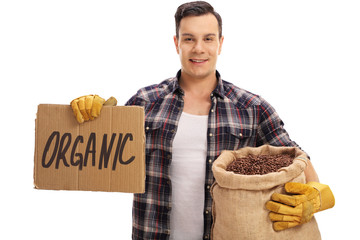 Poster - Farmer holding burlap sack with coffee and sign that says organi