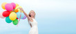 © Syda Productions - smiling woman with colorful balloons outside