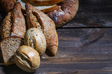 variety of bread on wooden table. 