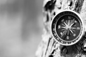 Wall Mural - black and white photo of an old compass in retro style / tourist compass closeup