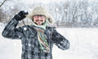 © scharfsinn86 - Adult man with beard wearing glasses. The man smiles. Winter, snow, a man in a fur hat. thumbs up