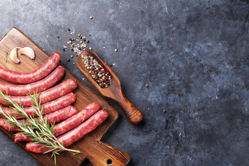 Raw sausages and ingredients for cooking