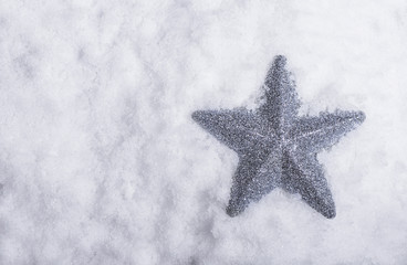 Wall Mural - silver star placed in snow