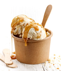 Wall Mural - ice cream with caramel sauce and ground nuts