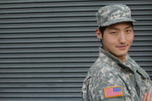 Army Asian Male Isolated On Gray With Copy Space