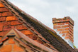 Damaged chimney needs repair old rooftop building exterior