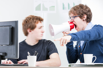 man shouting with a megaphone to his colleague