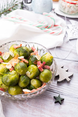 Wall Mural - Brussels sprouts with fried bacon and almonds. Delicious Christmas themed dinner table. Holiday concept.