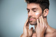 © pikselstock - Man applying face cream