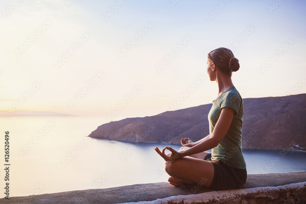 Young woman practicing yoga outdoors. Harmony and meditation concept. Healthy lifestyle - obrazy, fototapety, plakaty 