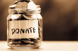 Close up Coins in glass jar for giving and donation concept
