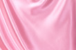 Close up wave luxury pink silk or satin fabric background