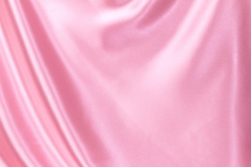 Close up wave luxury pink silk or satin fabric background