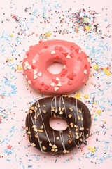 Funny glazed donuts on pink background