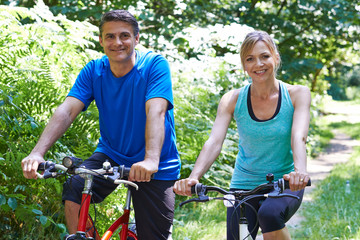 Mature Couple On Cycle Ride In Countryside